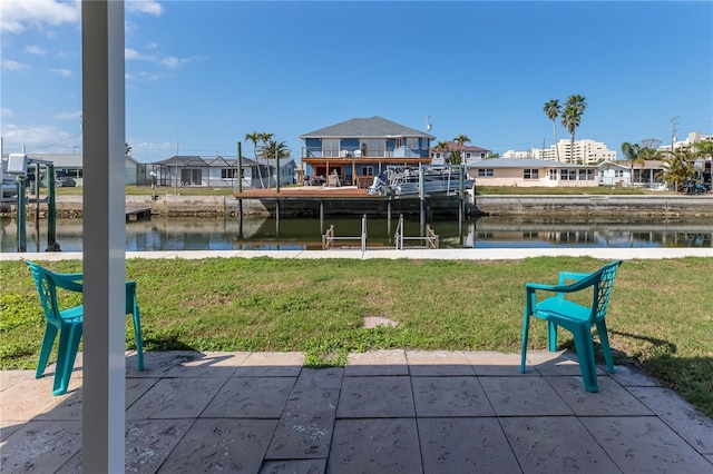 rear view of house with a yard and a water view