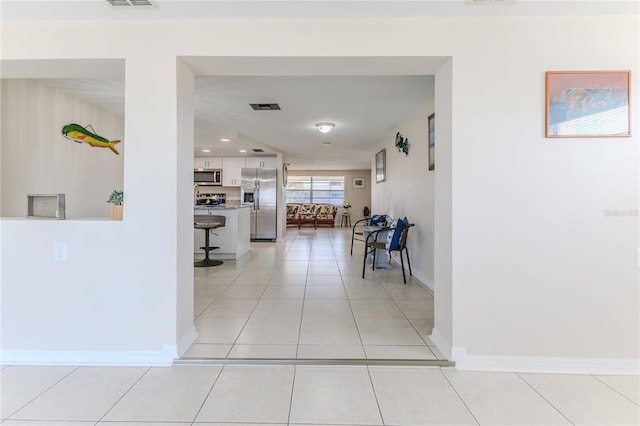 corridor featuring light tile patterned floors