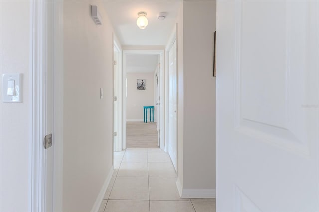 hall with light tile patterned floors