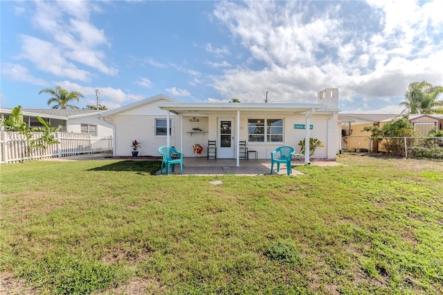 rear view of house featuring a yard