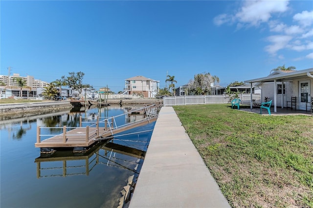 dock area with a yard and a water view