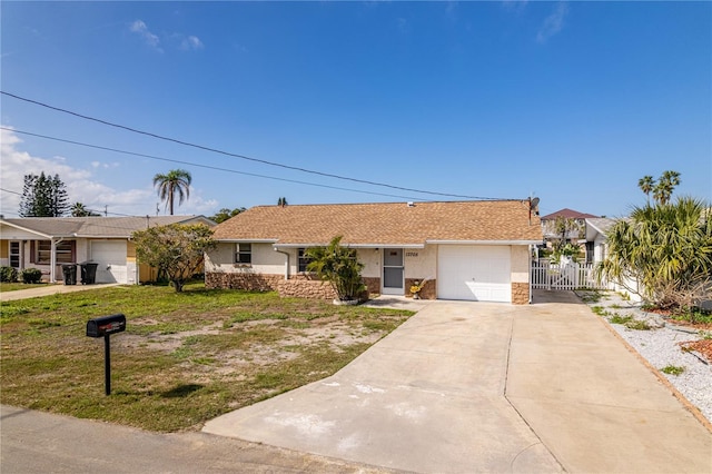 ranch-style house featuring a garage and a front lawn