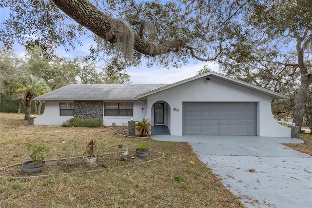 single story home with a garage and a front yard