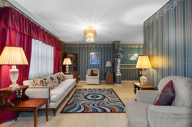 sitting room with hardwood / wood-style floors and a chandelier