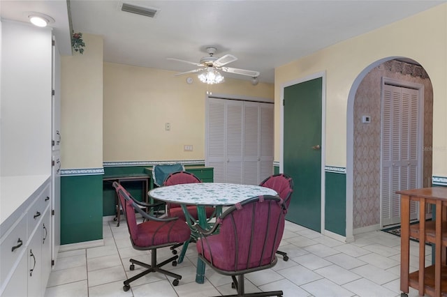 tiled dining area featuring ceiling fan