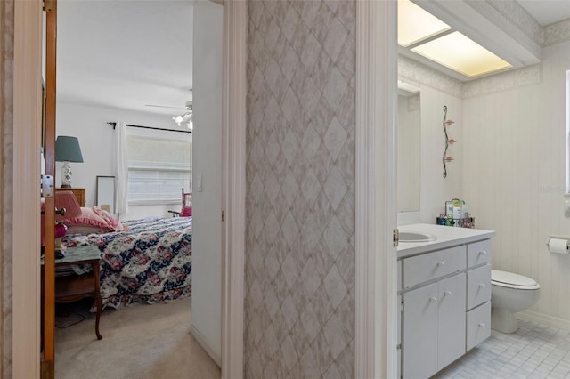 bathroom featuring vanity, ceiling fan, and toilet