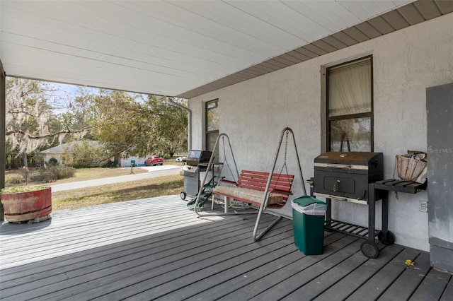 wooden terrace featuring area for grilling