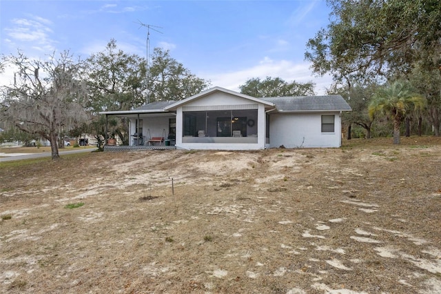 back of house featuring a sunroom