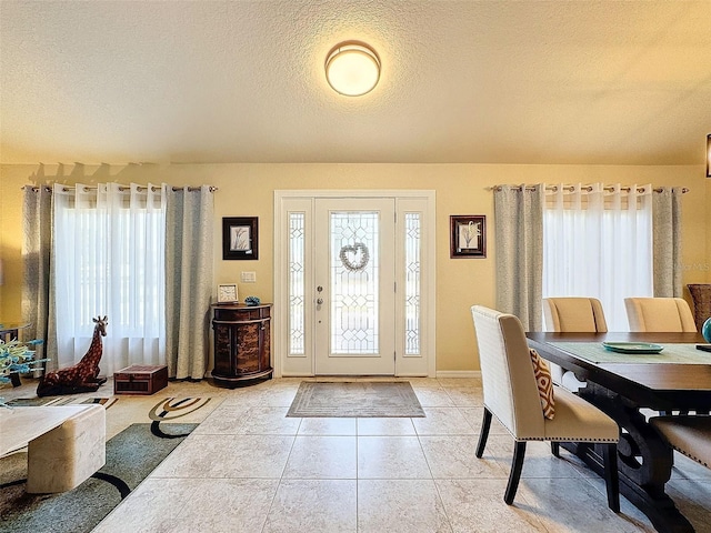 tiled entrance foyer featuring plenty of natural light and a textured ceiling