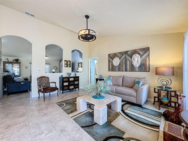 tiled living room with high vaulted ceiling