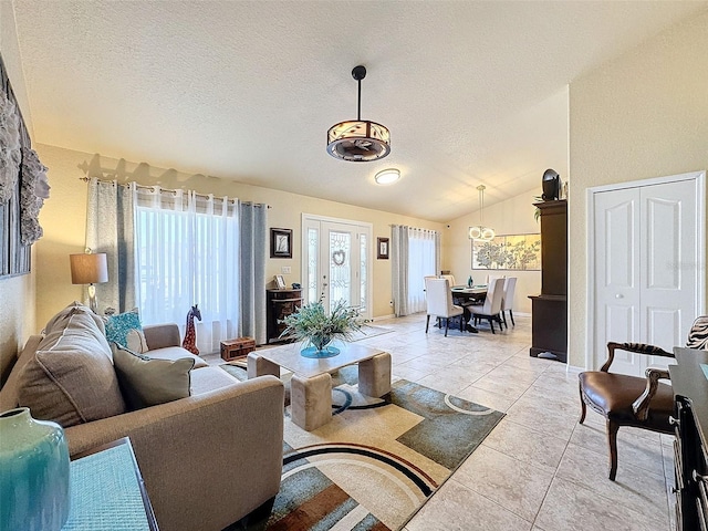 living room with lofted ceiling, a textured ceiling, and light tile patterned flooring