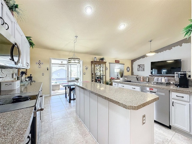 kitchen with stainless steel appliances, a center island, sink, and white cabinets