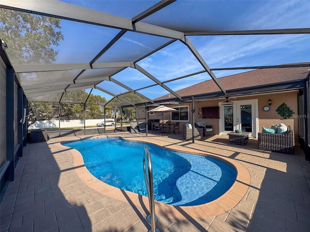 view of pool with an outdoor hangout area, a patio, ceiling fan, and glass enclosure