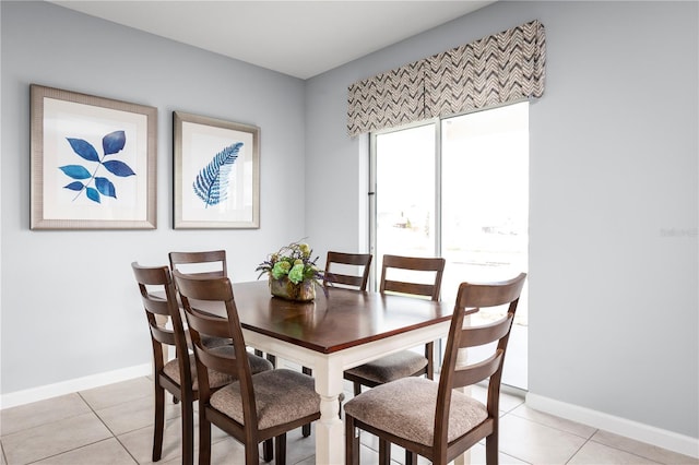 dining space featuring light tile patterned flooring