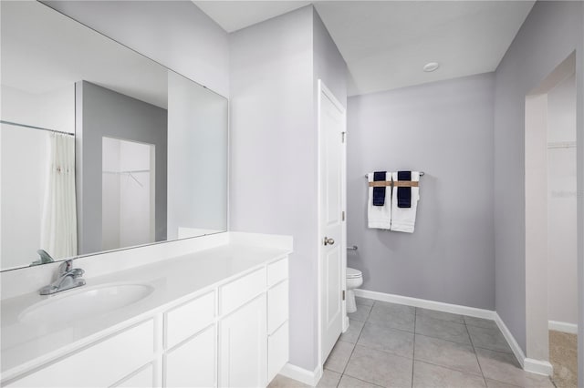 bathroom with vanity, tile patterned floors, and toilet