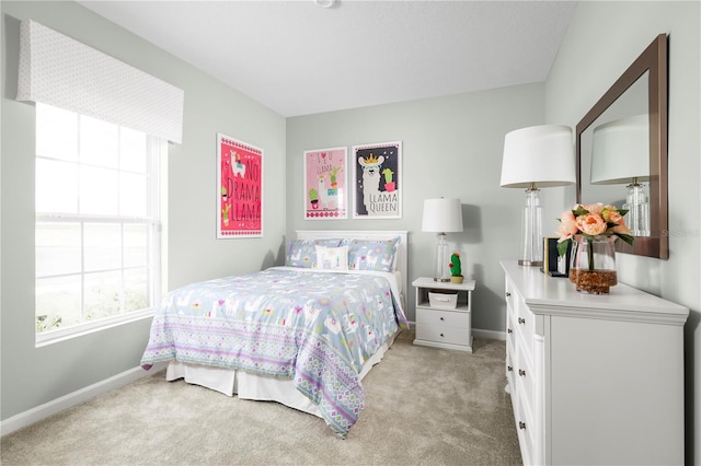 bedroom featuring light colored carpet