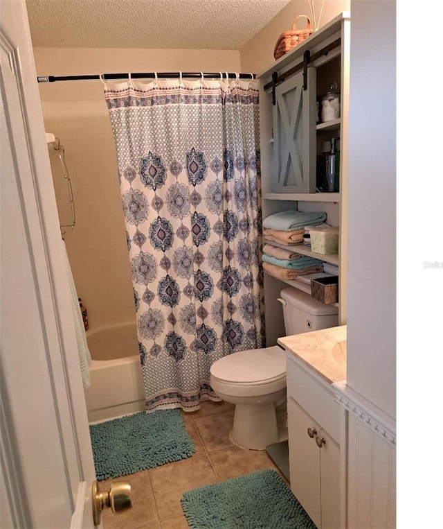 full bathroom with tile patterned flooring, vanity, shower / tub combo, toilet, and a textured ceiling