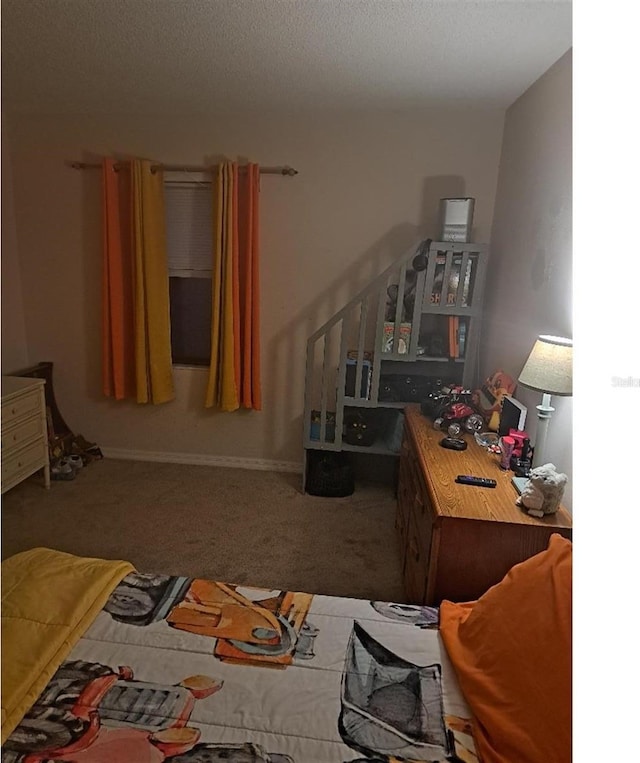 carpeted bedroom with a textured ceiling