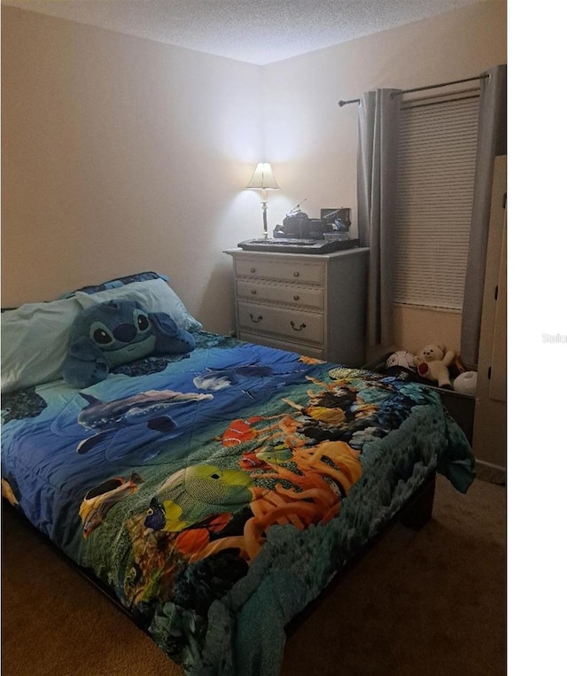 bedroom with carpet floors and a textured ceiling