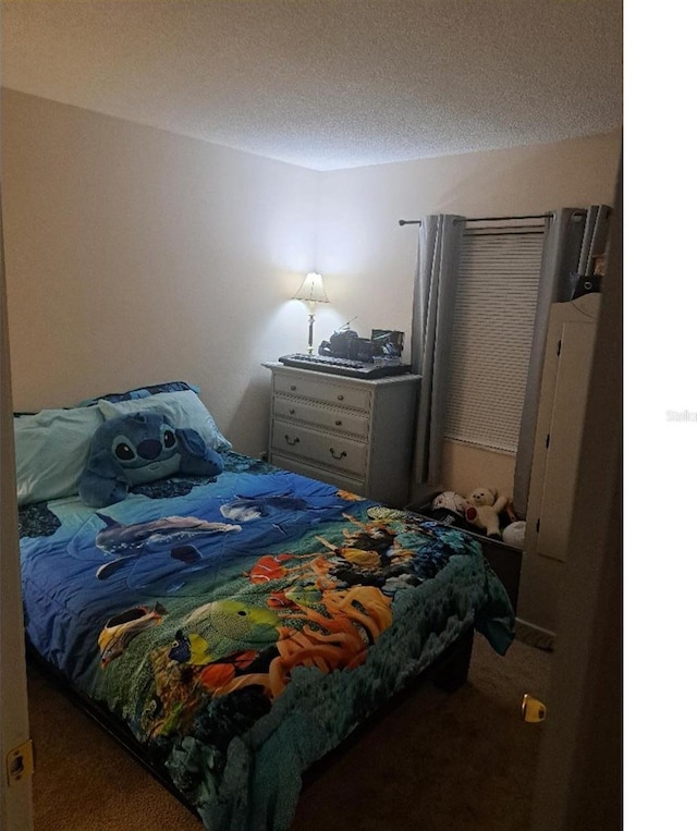 carpeted bedroom with a textured ceiling