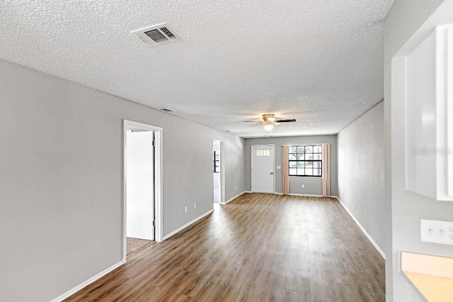 unfurnished room featuring hardwood / wood-style floors, a textured ceiling, and ceiling fan