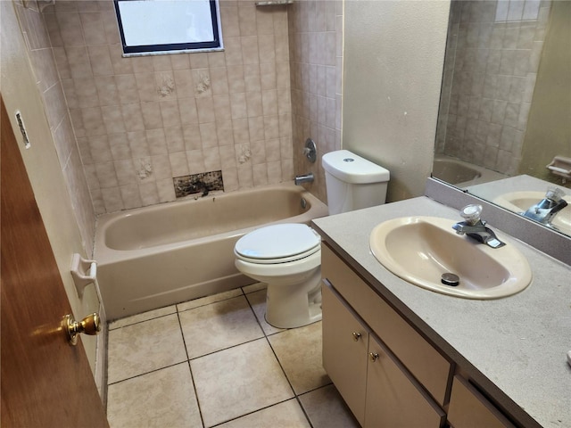 full bathroom featuring tile patterned floors, vanity, toilet, and tiled shower / bath