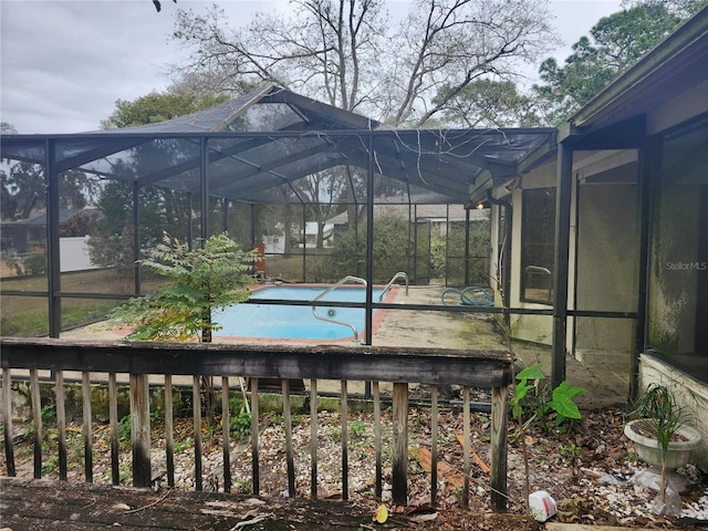 view of swimming pool featuring a lanai