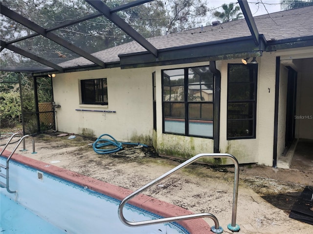 rear view of property with glass enclosure