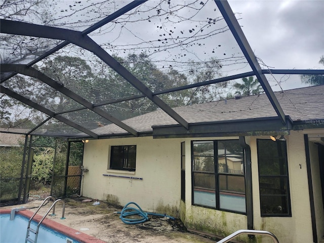 back of house featuring a lanai and a patio area