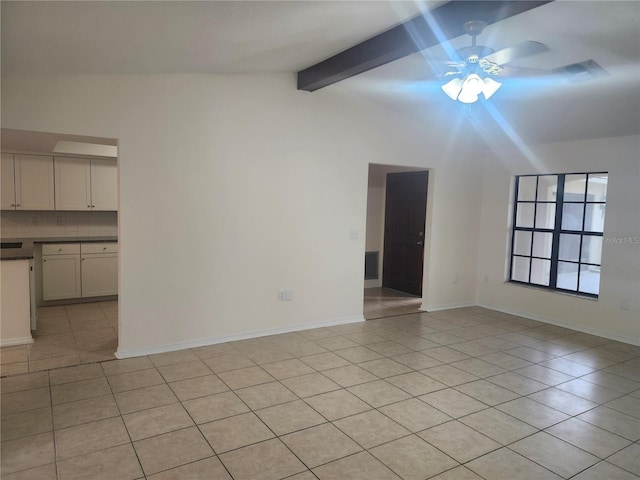 unfurnished living room with ceiling fan, light tile patterned floors, and baseboards