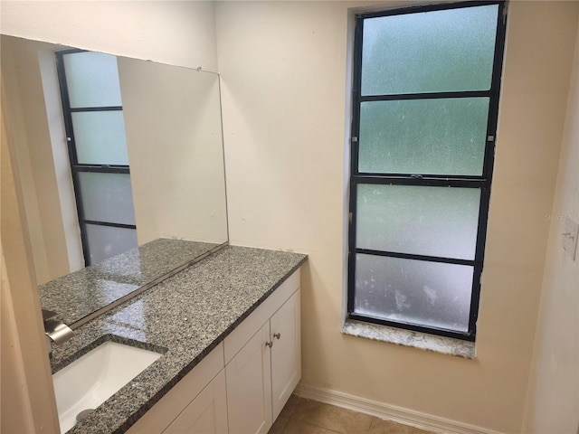 bathroom featuring baseboards, vanity, and tile patterned flooring