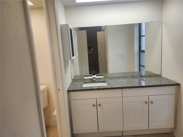 bathroom with toilet and vanity