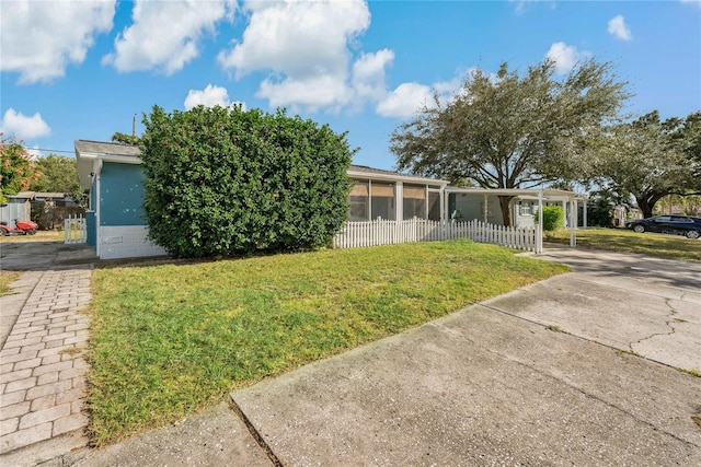 view of front facade with a sunroom and concrete driveway