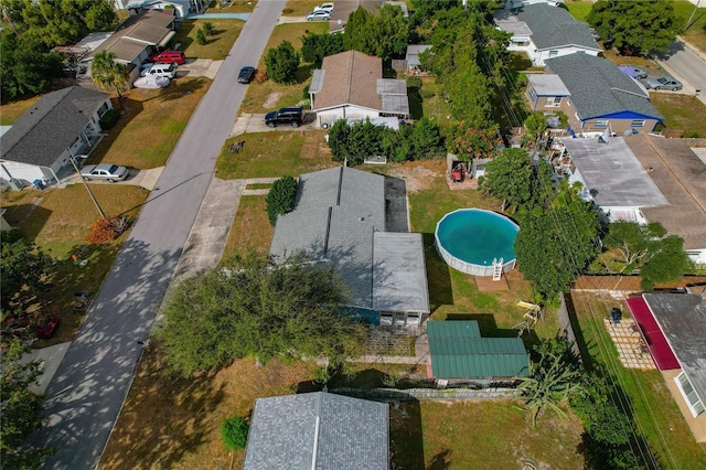aerial view of property's location with nearby suburban area and a pool
