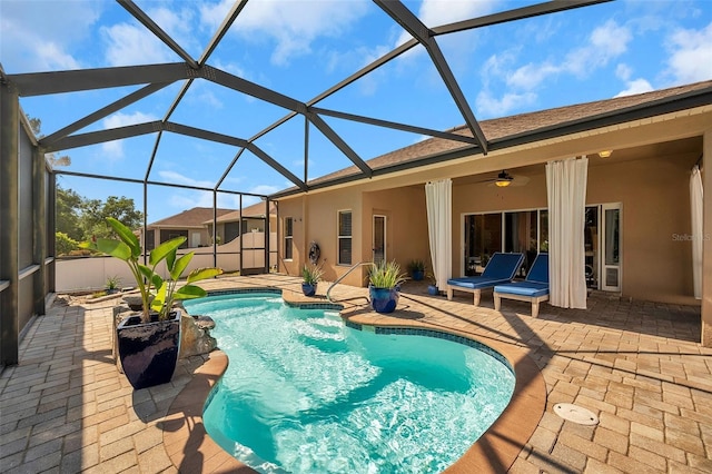 view of pool featuring ceiling fan, a lanai, and a patio area