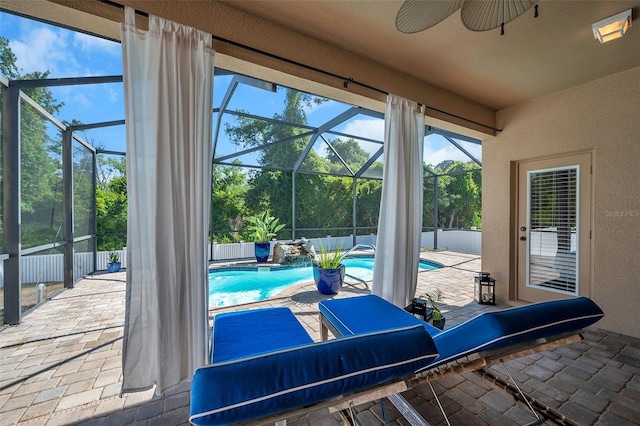 interior space featuring pool water feature, ceiling fan, a fenced in pool, and glass enclosure