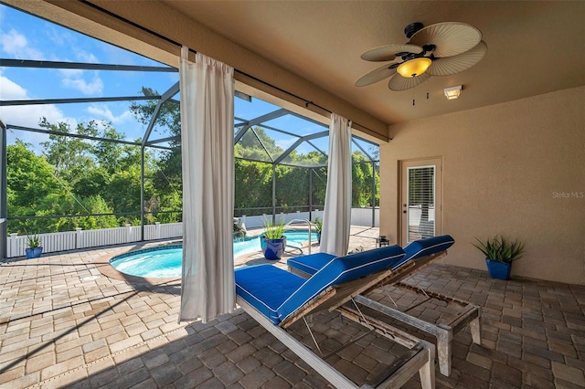 view of patio with ceiling fan, a lanai, and a fenced in pool