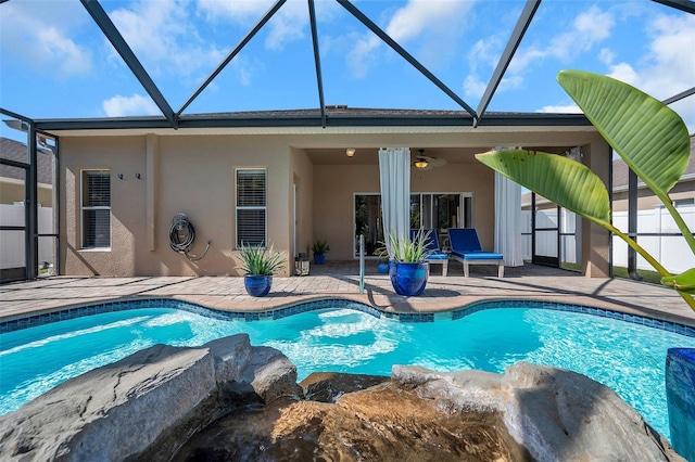 view of pool featuring ceiling fan, a lanai, and a patio