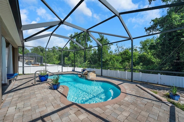 view of swimming pool with a patio and a lanai