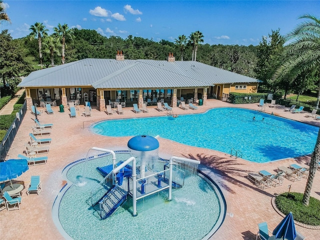 view of swimming pool with a patio and pool water feature