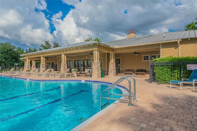 view of swimming pool featuring a patio and ceiling fan