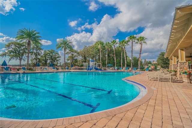 view of pool featuring a patio area and a playground