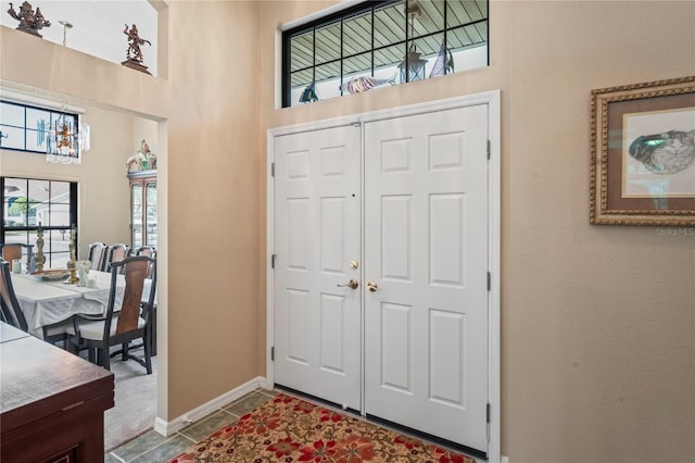 tiled foyer with a high ceiling