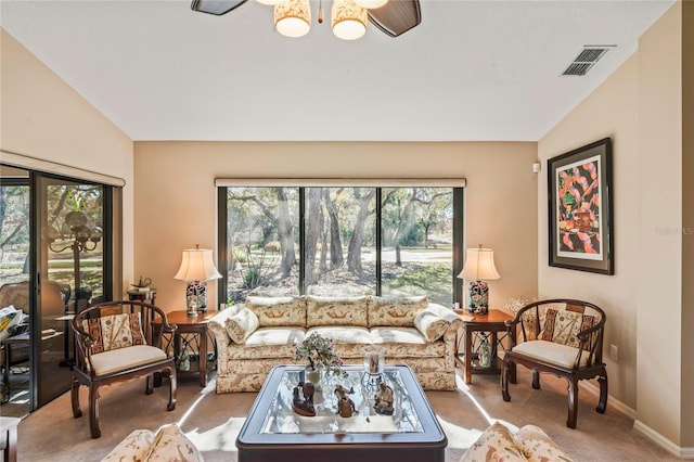 carpeted living room featuring lofted ceiling