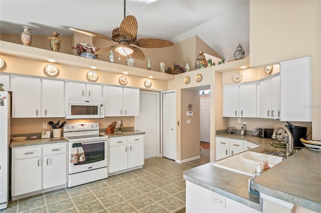 kitchen featuring lofted ceiling, sink, white appliances, ceiling fan, and white cabinets