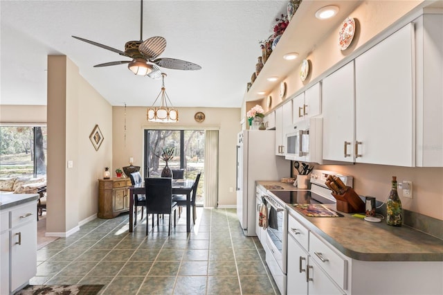 kitchen with ceiling fan, a healthy amount of sunlight, white cabinets, and white appliances