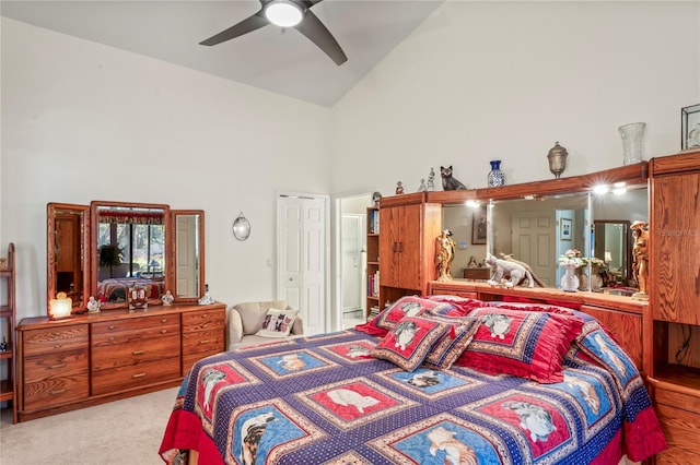 bedroom featuring ceiling fan, high vaulted ceiling, and light carpet