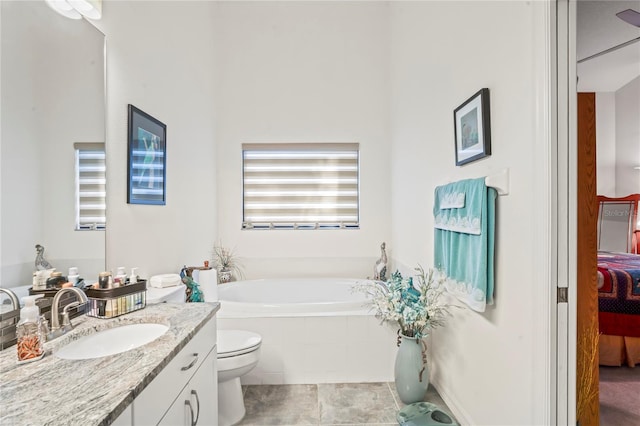 bathroom with tile patterned floors, vanity, toilet, and tiled tub