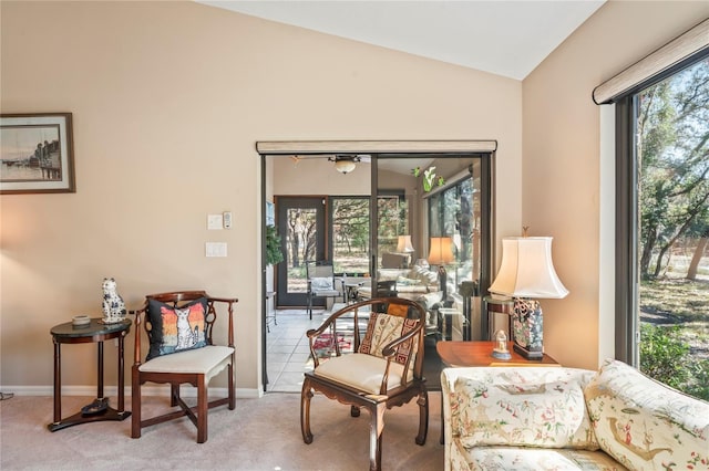 living area with vaulted ceiling, light carpet, a wealth of natural light, and french doors