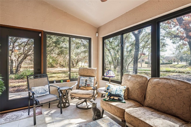 sunroom / solarium with ceiling fan and lofted ceiling